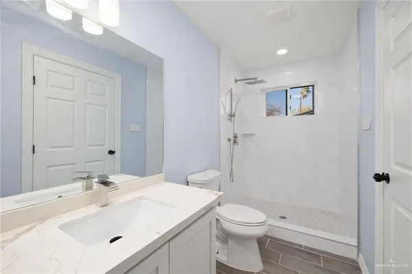 a bathroom with a sink toilet and shower