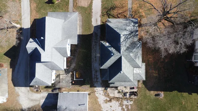 an aerial view of a house with a yard