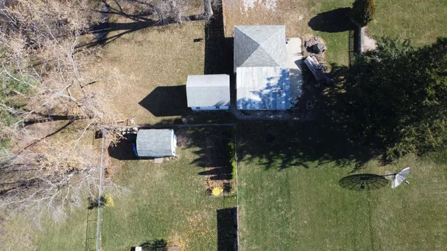 an aerial view of houses covered with trees
