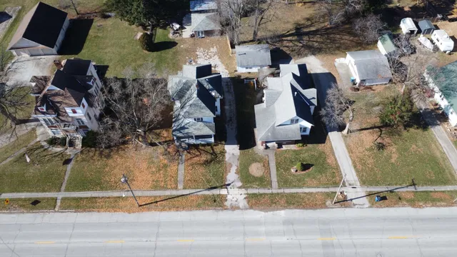 an aerial view of a house with a yard