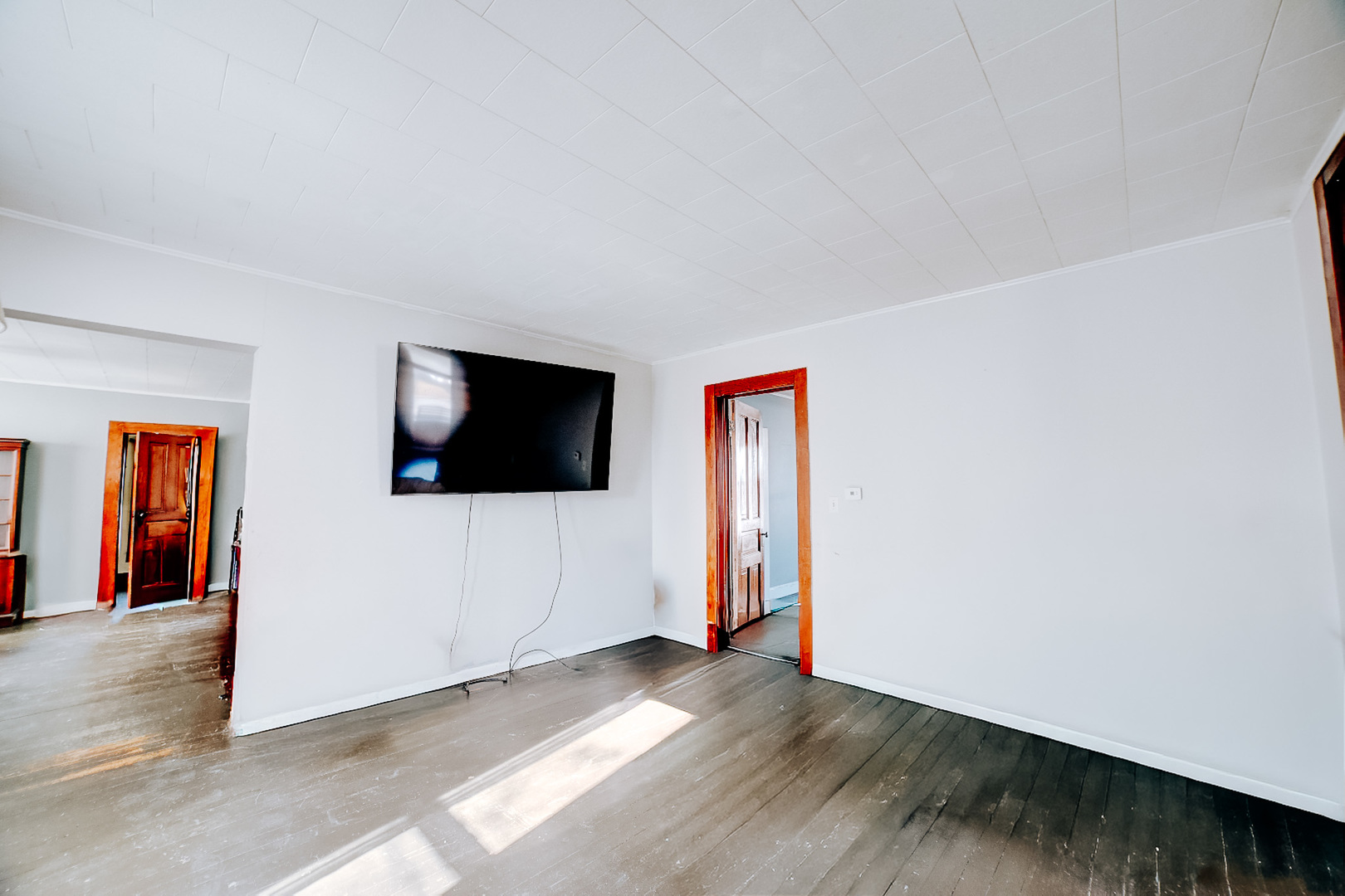 204 North Chicago Street Milford, IL 60953 - Photo 15 of 48 a view of a livingroom with wooden floor and a flat screen tv