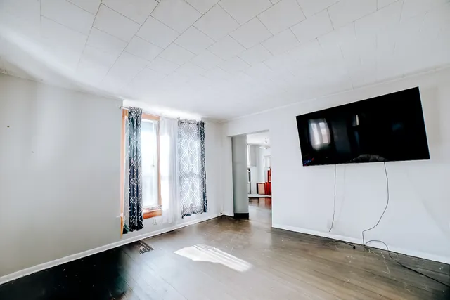 a view of a livingroom with an empty space and a flat screen tv