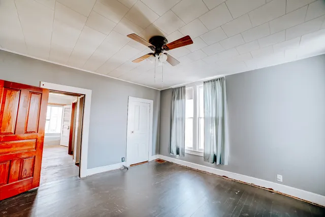 wooden floor in an empty room with a window