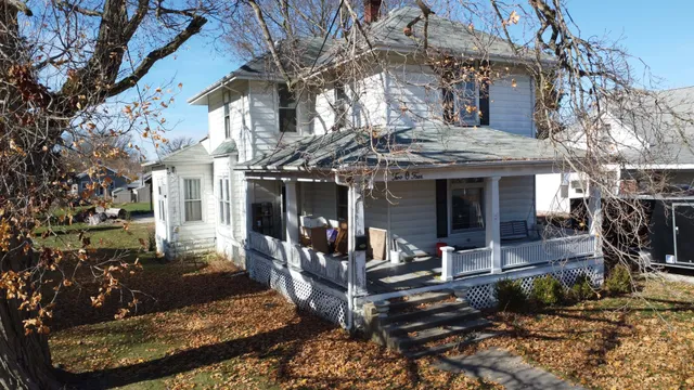 a view of a house with backyard outdoor seating area