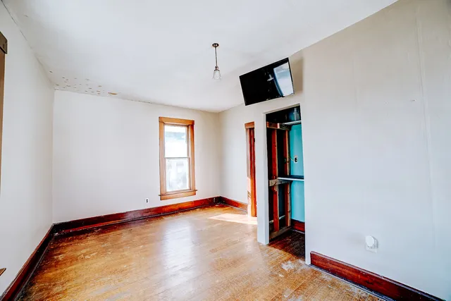 a view of room with wooden floor and window