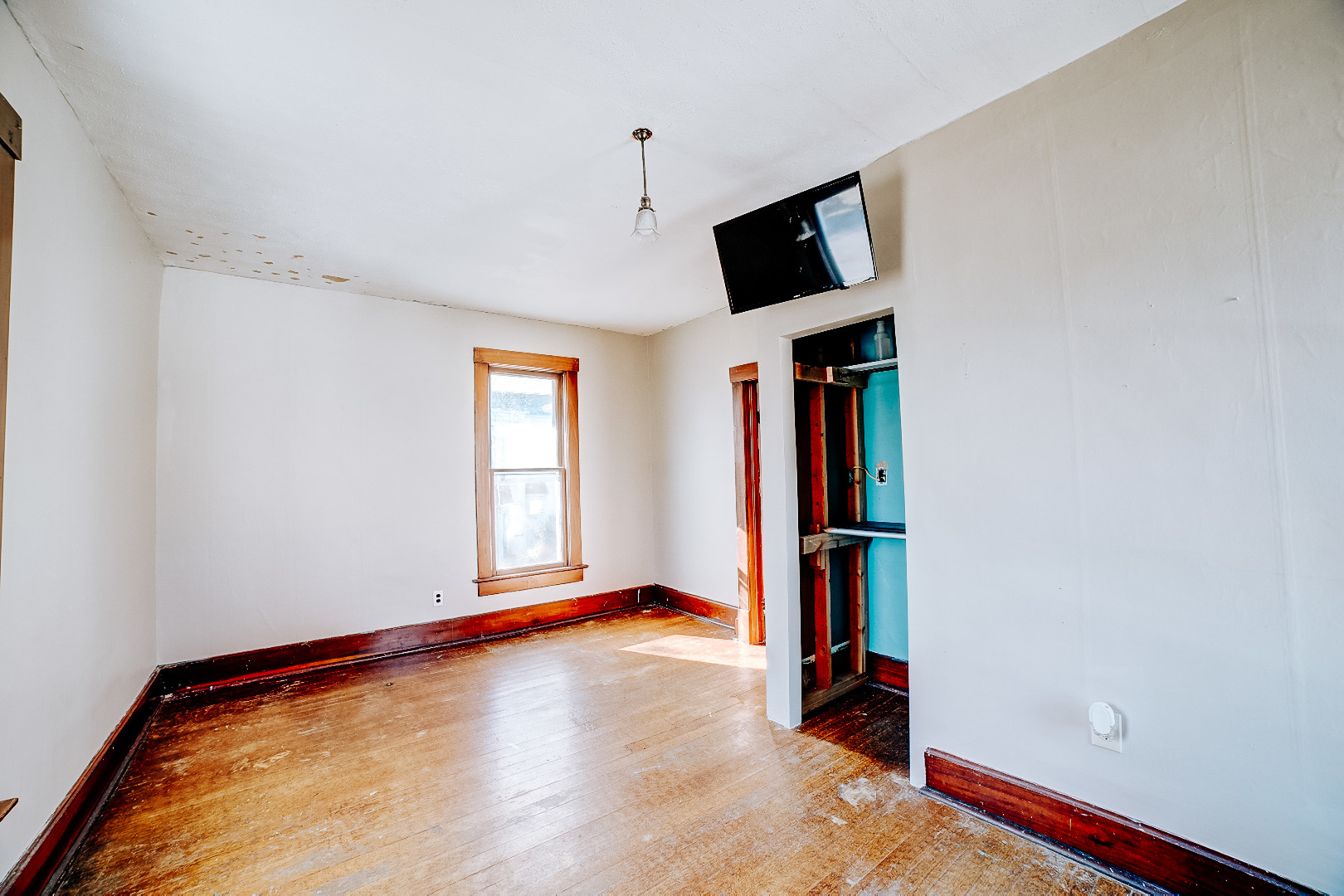204 North Chicago Street Milford, IL 60953 - Photo 38 of 48 a view of room with wooden floor and window