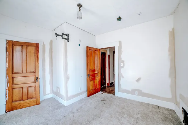 a view of an empty room with closet area