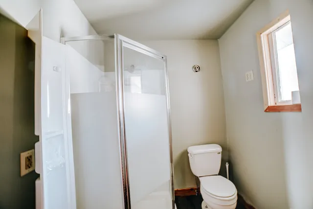a white toilet sitting next to a bathroom sink