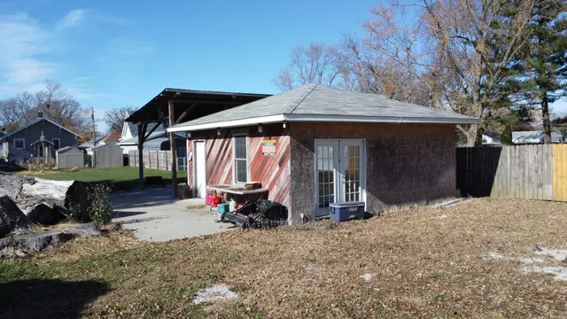 a backyard of a house with table and chairs