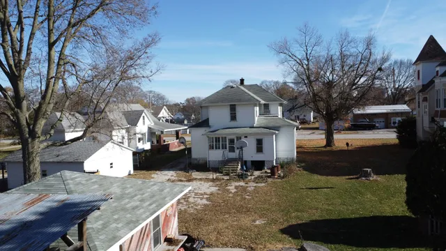 a large tree in front of a house