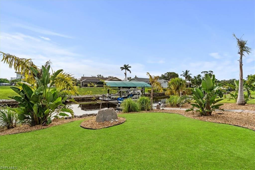 20660 Park Place Estero, FL 33928 - Photo 19 of 26 a view of a table and chairs in the garden