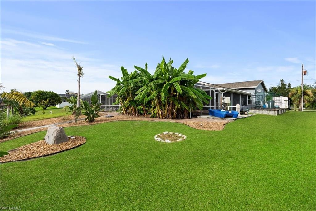 20660 Park Place Estero, FL 33928 - Photo 20 of 26 a view of yard with swimming pool and green space