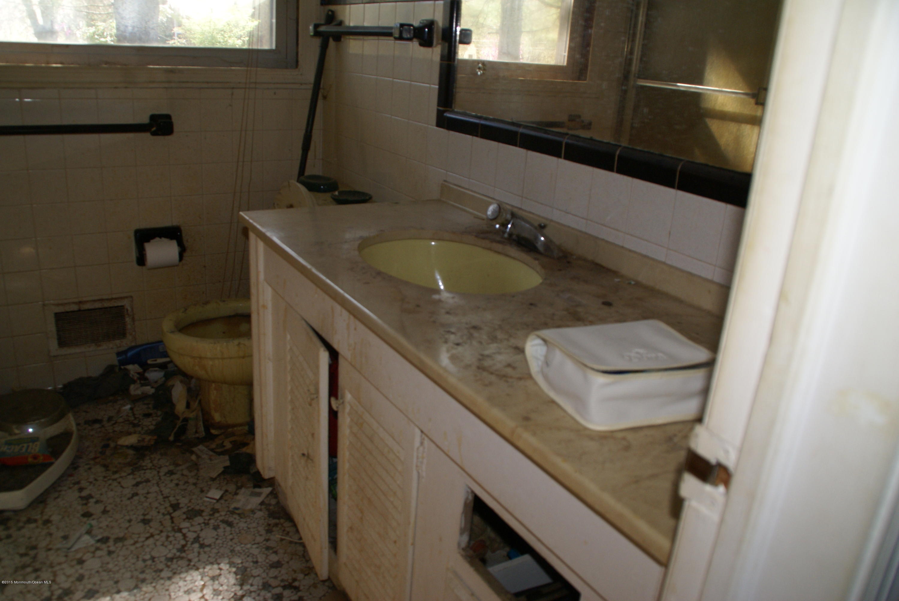 440 Burlington Road Freehold, NJ 07728 - Photo 14 of 21 a bathroom with a granite countertop sink a toilet and a mirror