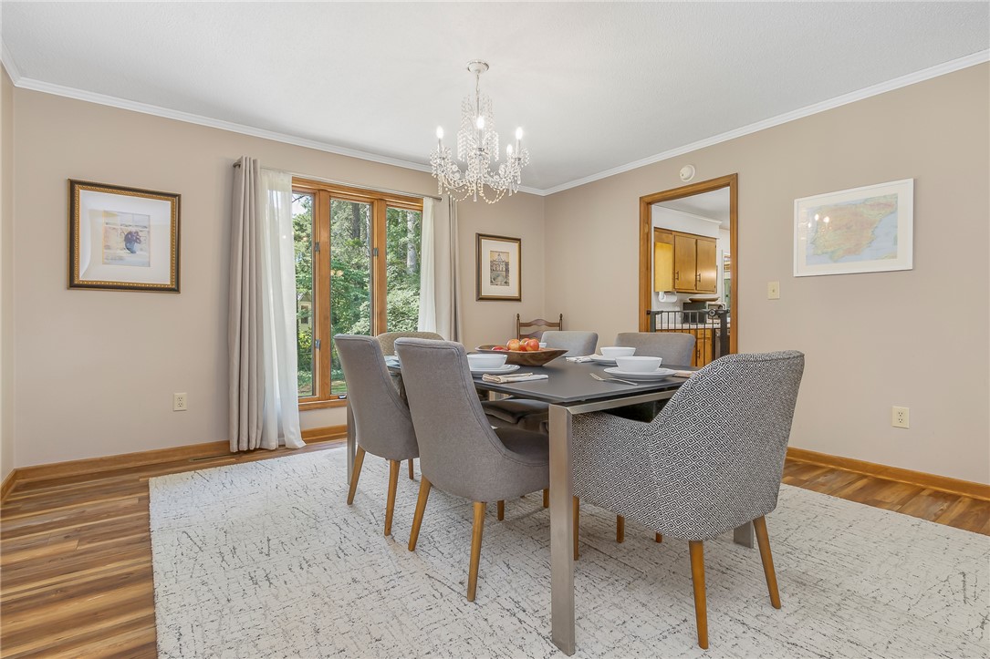 207 Laurel Ridge Road Anderson, SC 29621 - Photo 13 of 50 A well-lit dining area features polished wood flooring and a elegant chandelier, perfect for memorable meals.