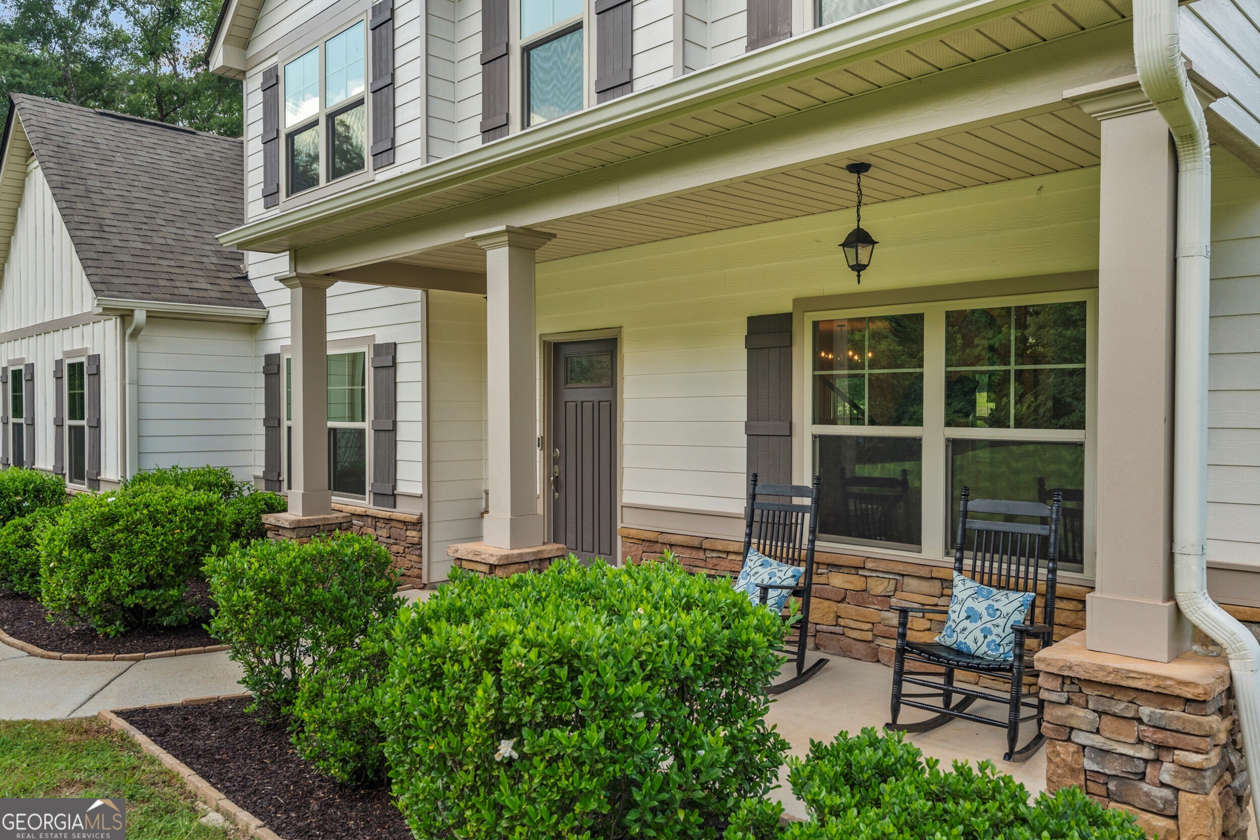 1612 Dennis Smith Road Pine Mountain, GA 31822 - Photo 2 of 33 front view of a brick house with a chairs and table in a patio