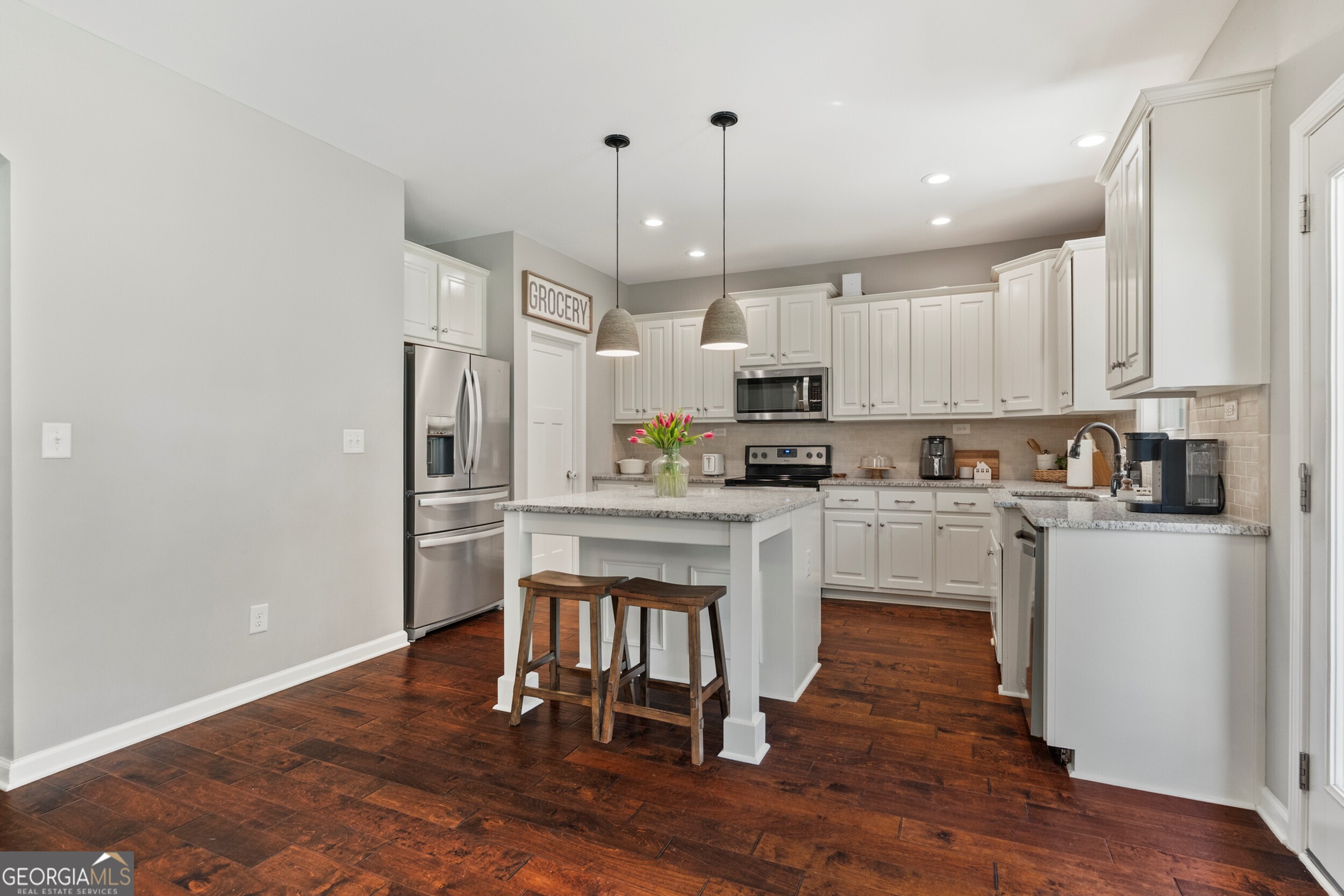1612 Dennis Smith Road Pine Mountain, GA 31822 - Photo 6 of 33 a kitchen with white cabinets and stainless steel appliances