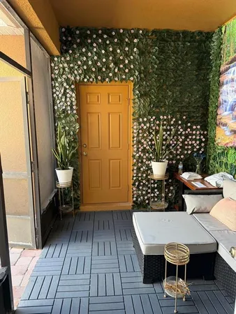 an outdoor sitting area with a table and chairs