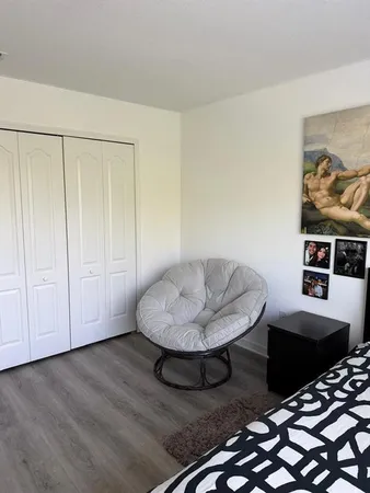 a bedroom with furniture and a wooden floor