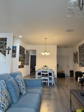 a living room with furniture and chandelier