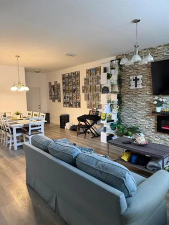 a living room with fireplace furniture and a flat screen tv