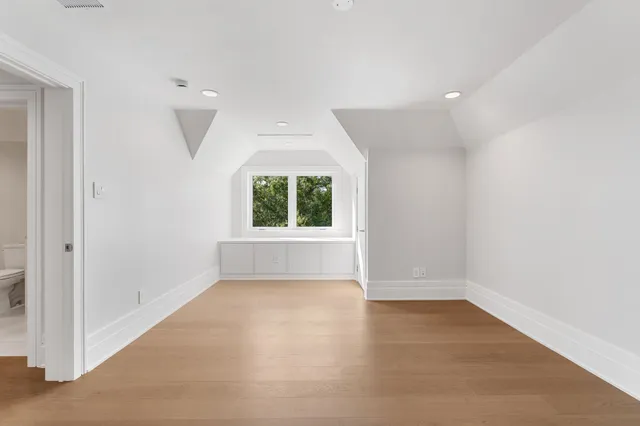 a bathroom with a sink toilet vanity and tub