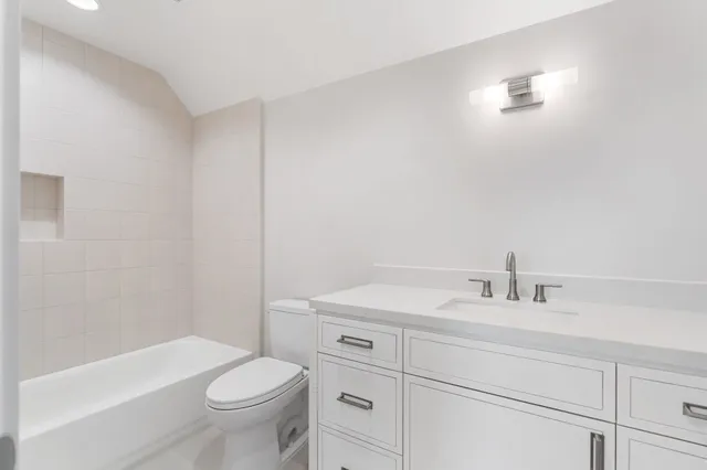 a kitchen with white cabinets and white appliances