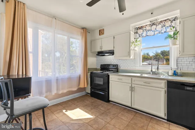 a kitchen with stainless steel appliances a stove a sink and a refrigerator