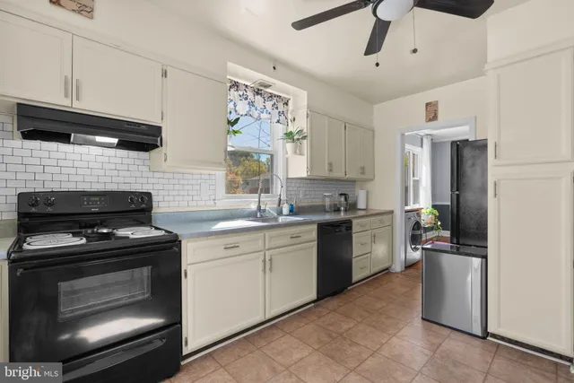 a kitchen with a stove sink and refrigerator