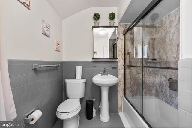 a bathroom with a toilet a sink and a shower