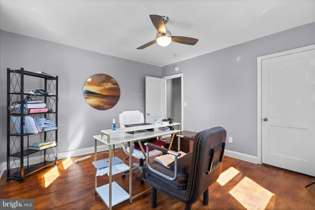 a work room with furniture and wooden floor