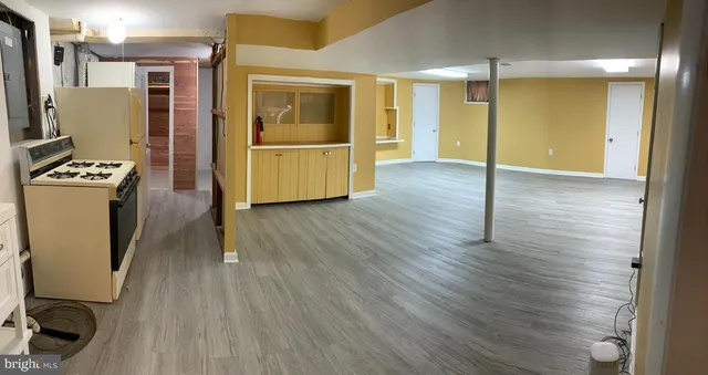 a view of a kitchen with refrigerator and wooden floor