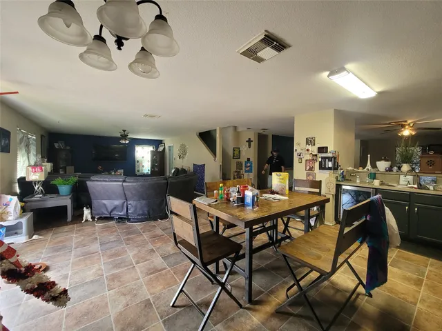 a living room with lots of furniture and a chandelier
