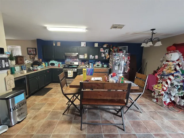 a room with lots of furniture and a chandelier