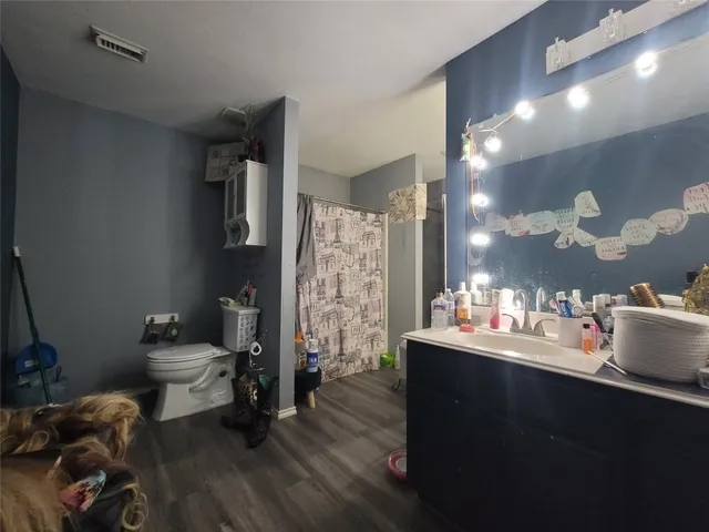 a room with a wooden floor and furniture