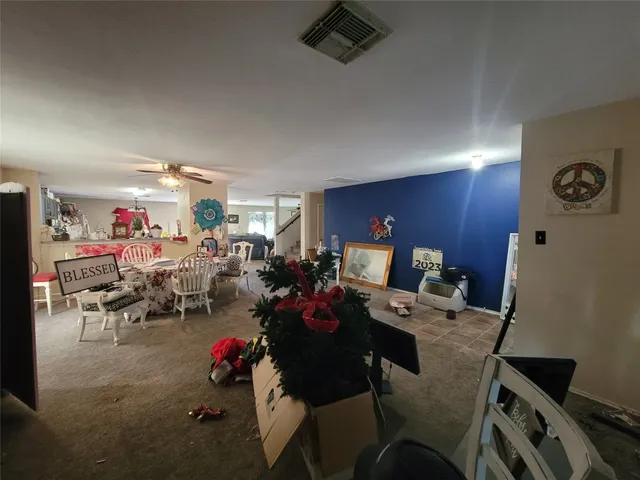 a view of a dining room with furniture and a window