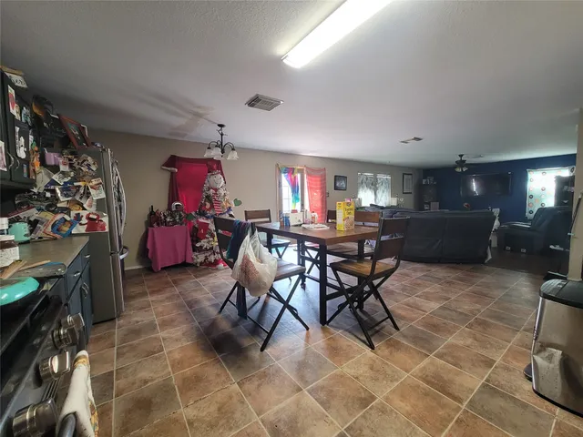 a view of a dining room with furniture and a garage