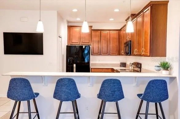 a kitchen with stainless steel appliances a refrigerator a microwave a sink and a stove