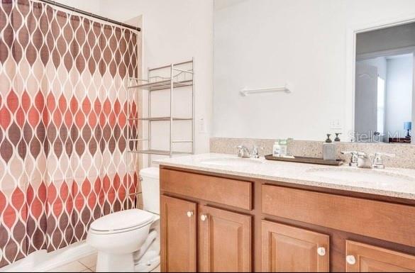 9342 Shepton Street Orlando, FL 32825 - Photo 5 of 8 a bathroom with a granite countertop sink and a toilet