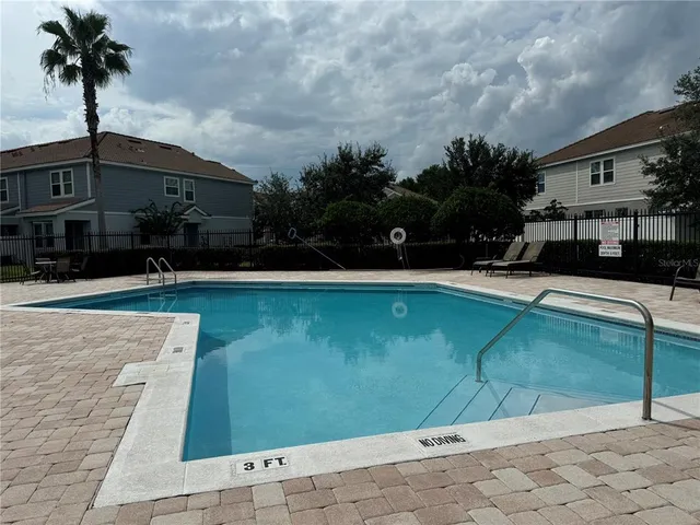 a view of a swimming pool with a yard