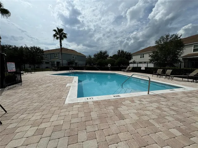 a view of a swimming pool with a yard
