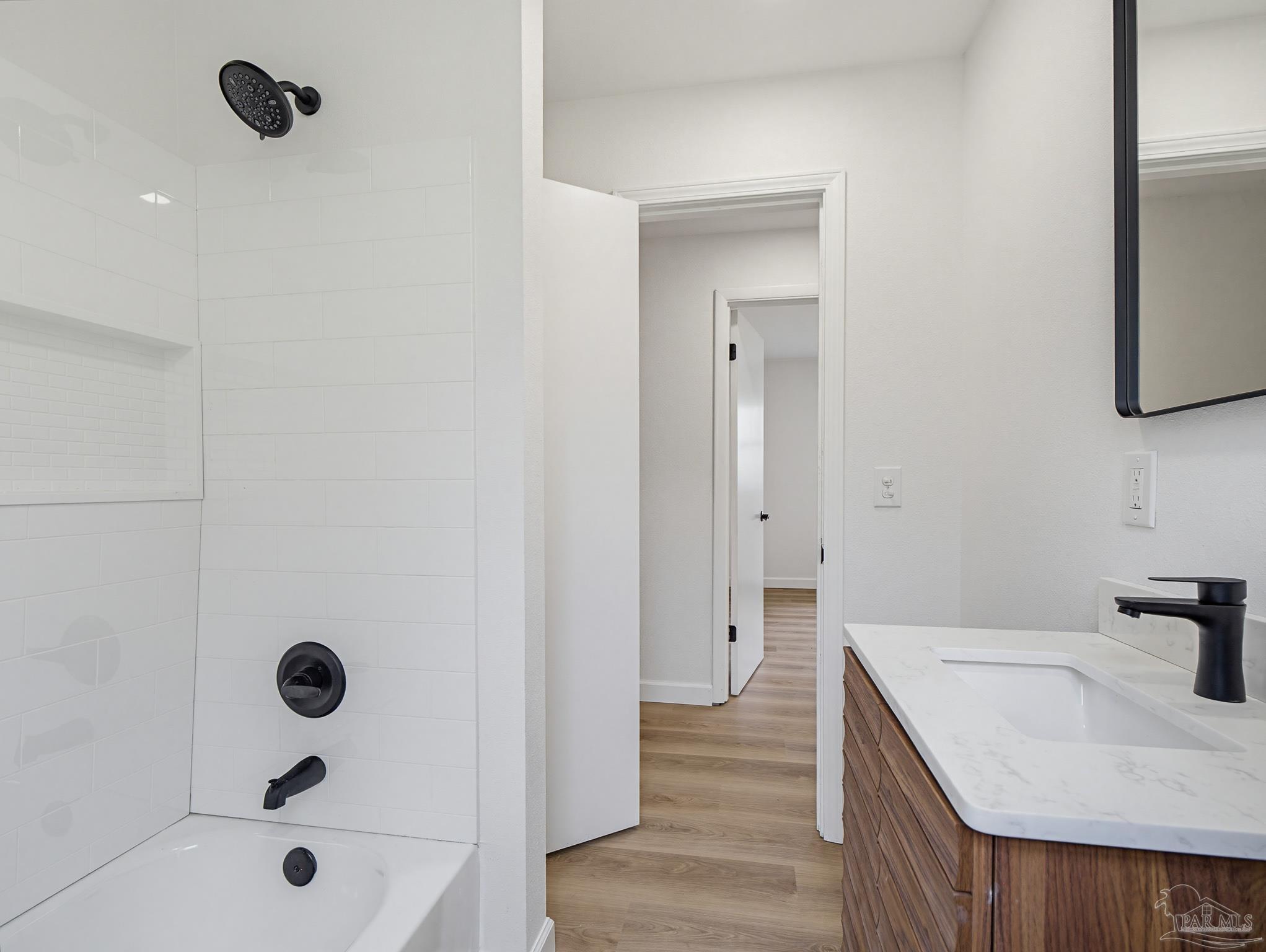 125 Madrid Road Cantonment, FL 32533 - Photo 12 of 16 a bathroom with a tub a sink and a large mirror