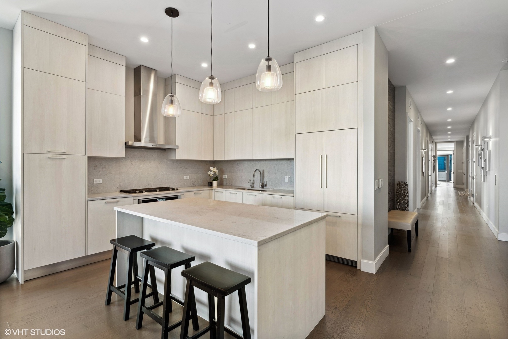 39 North Aberdeen Street, Unit PHN Chicago, IL 60607 - Photo 11 of 46 a kitchen with kitchen island a stove a table a sink refrigerator and cabinets