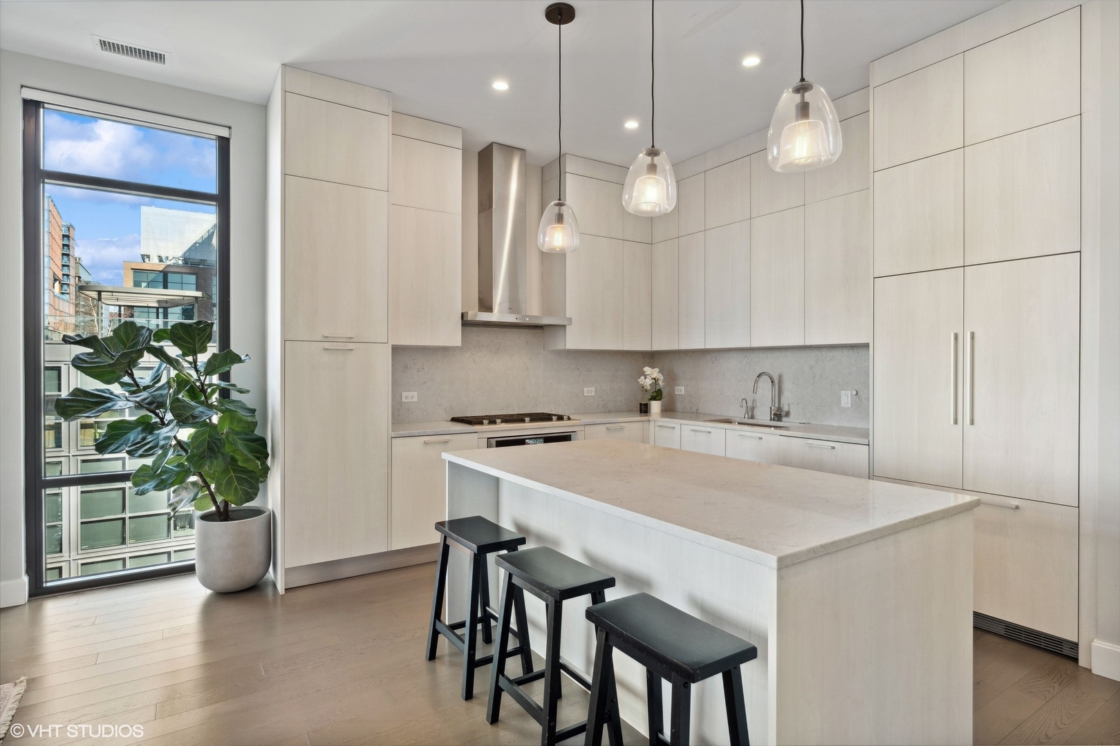 39 North Aberdeen Street, Unit PHN Chicago, IL 60607 - Photo 12 of 46 a kitchen with a table a sink and cabinets