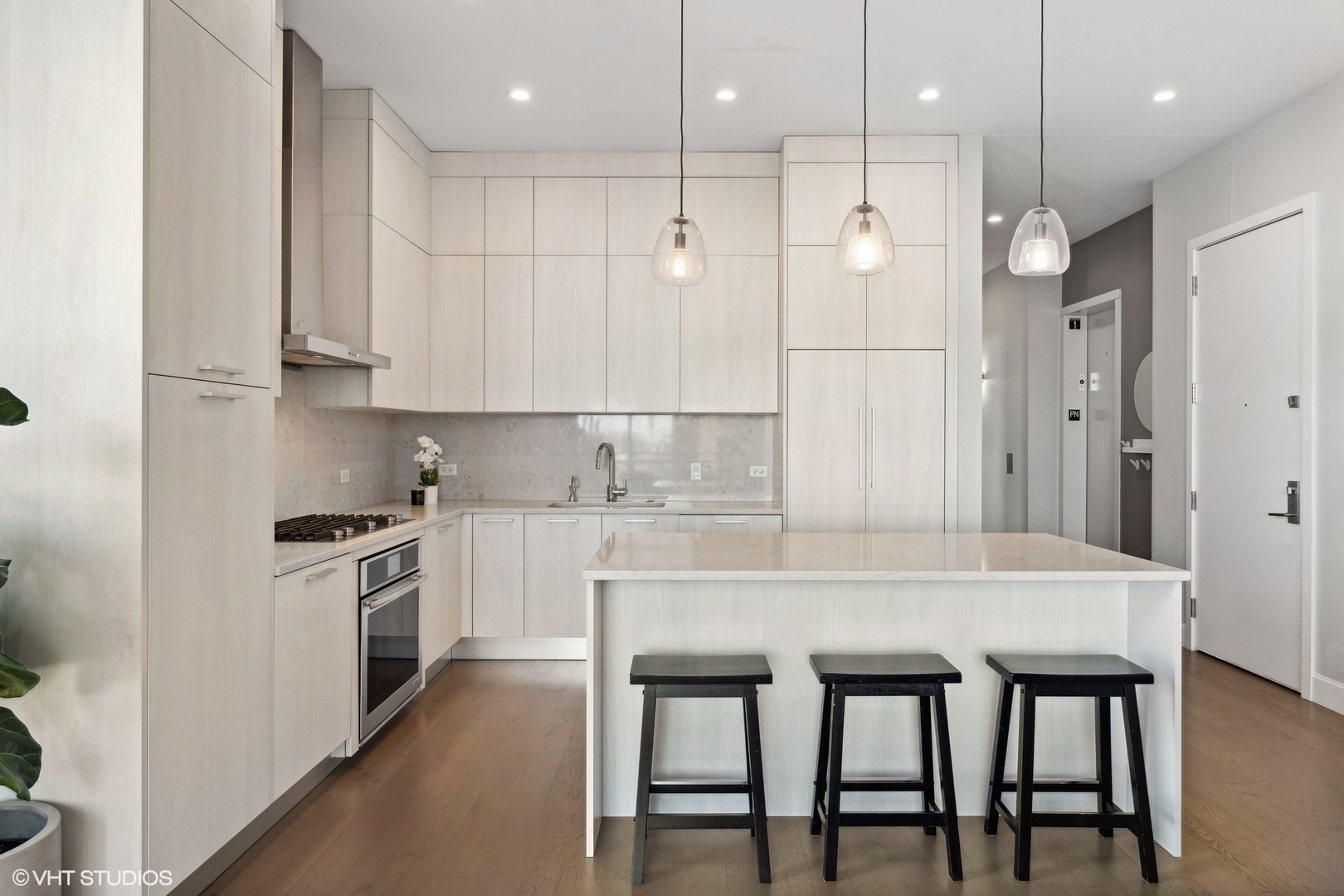 39 North Aberdeen Street, Unit PHN Chicago, IL 60607 - Photo 14 of 46 a kitchen with stainless steel appliances granite countertop a table chairs sink and cabinets