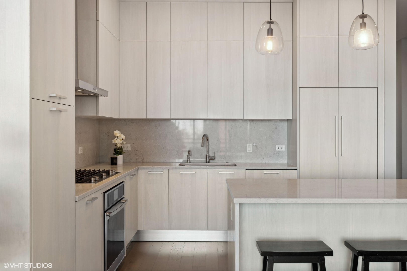 39 North Aberdeen Street, Unit PHN Chicago, IL 60607 - Photo 15 of 46 a kitchen with granite countertop white cabinets and white appliances
