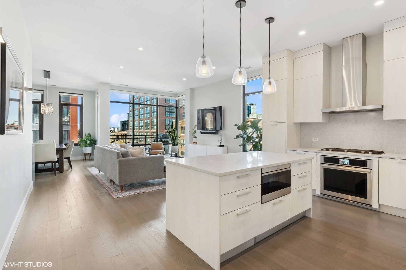 39 North Aberdeen Street, Unit PHN Chicago, IL 60607 - Photo 16 of 46 a kitchen with kitchen island white cabinets and white appliances