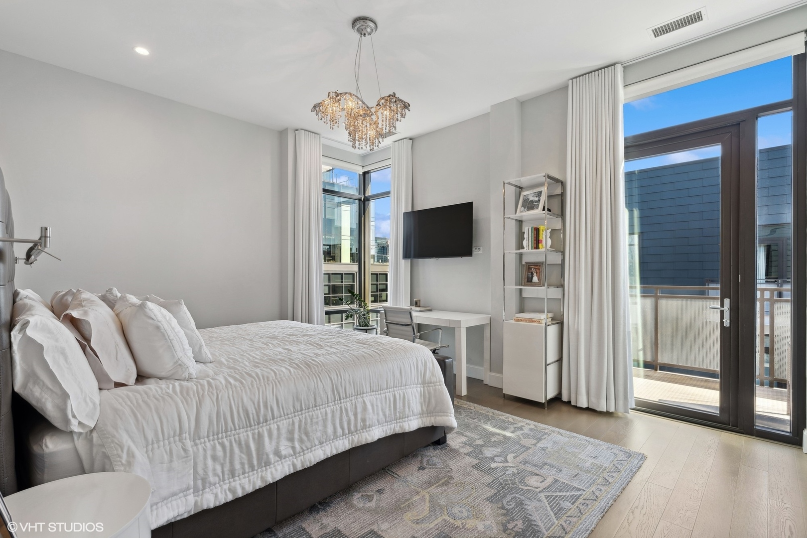 39 North Aberdeen Street, Unit PHN Chicago, IL 60607 - Photo 21 of 46 a bedroom with a bed and a chandelier