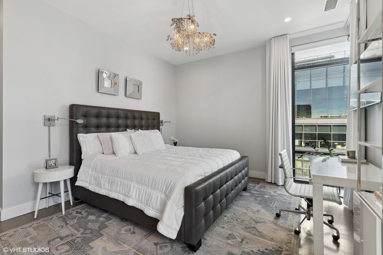 39 North Aberdeen Street, Unit PHN Chicago, IL 60607 - Photo 23 of 46 a bedroom with a bed and a table with potted plant