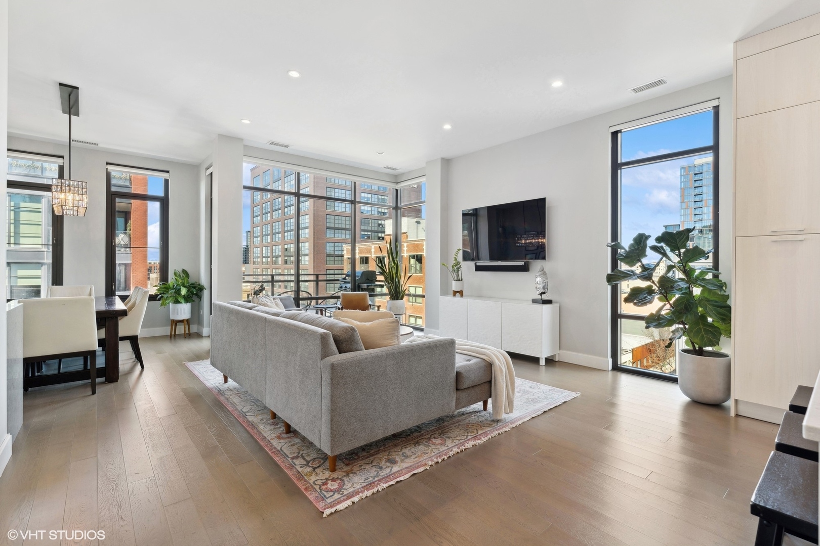 39 North Aberdeen Street, Unit PHN Chicago, IL 60607 - Photo 4 of 46 a living room with furniture and a flat screen tv