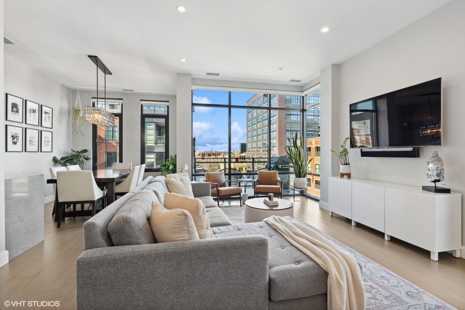 39 North Aberdeen Street, Unit PHN Chicago, IL 60607 - Photo 5 of 46 a living room with furniture and a flat screen tv